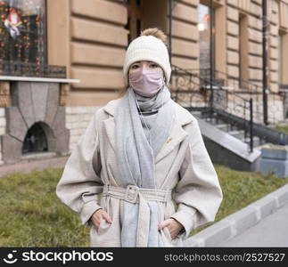 front view woman city with medical mask