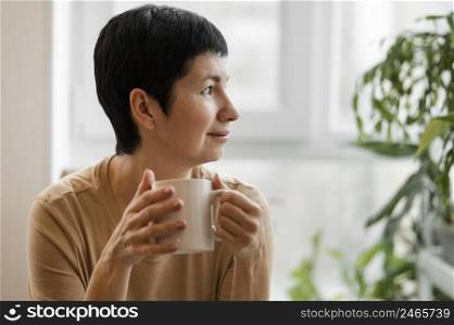 front view woman enjoying drink mug
