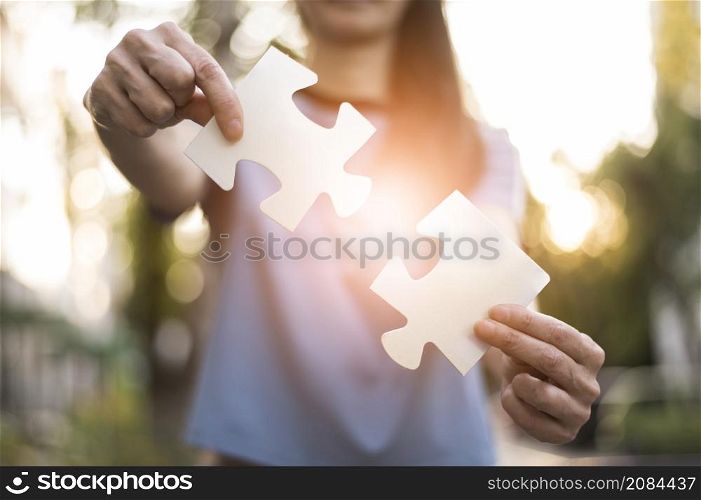 front view woman holding puzzle pieces