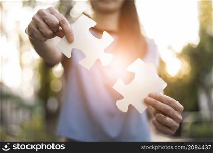 front view woman holding puzzle pieces