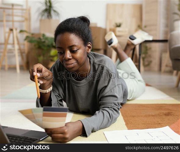 front view woman making plans redecorate house with color palette