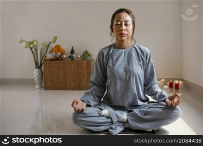 front view woman meditating room with copy space