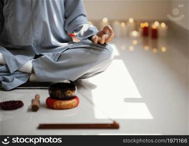 front view woman meditating with incense candles. High resolution photo. front view woman meditating with incense candles. High quality photo