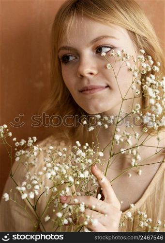 front view woman posing with beautiful flowers