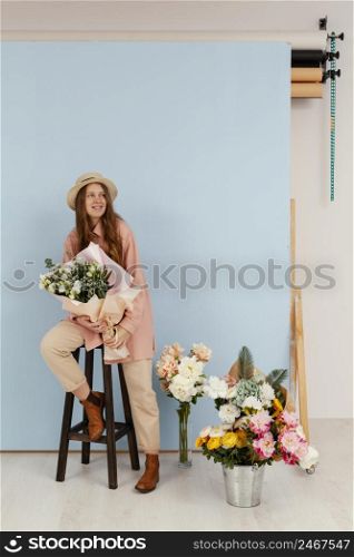 front view woman posing with bouquet spring flowers