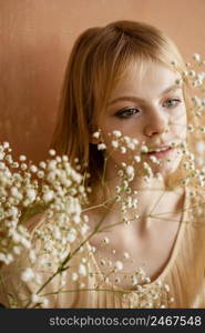 front view woman posing with delicate flowers