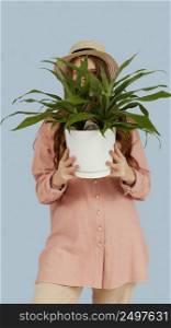 front view woman posing with pot plant