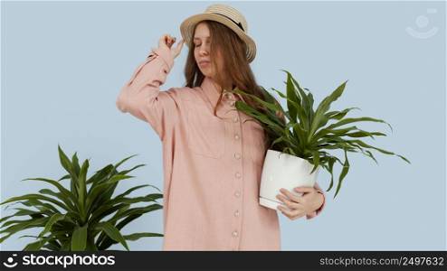 front view woman posing with pots plants