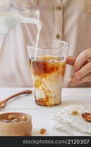 front view woman preparing milk tea