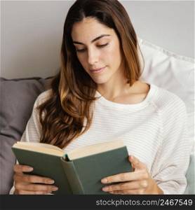 front view woman reading book home