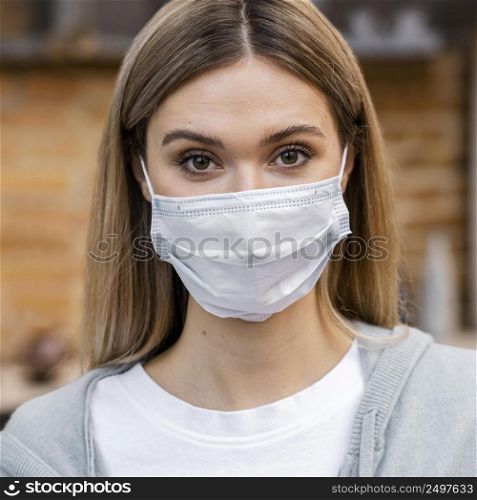 front view woman salon with medical mask