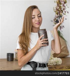 front view woman smelling coffee beans