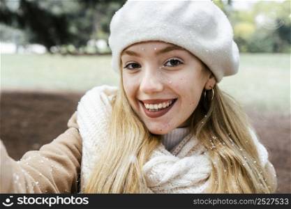 front view woman taking selfie park during winter