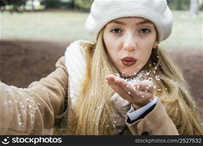 front view woman taking selfie park during winter with snow