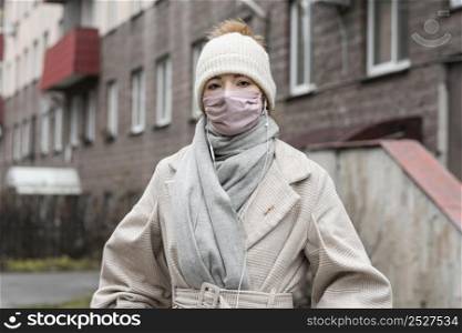 front view woman wearing medical mask city
