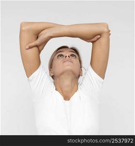 front view woman with doing physiotherapy while lifting arms up
