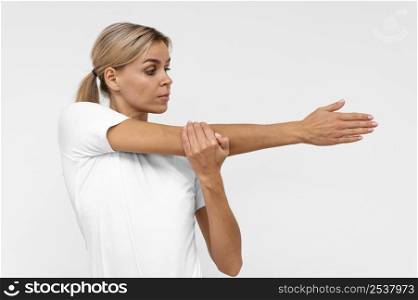 front view woman with doing physiotherapy with arms