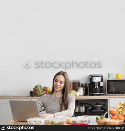 front view woman with food laptop