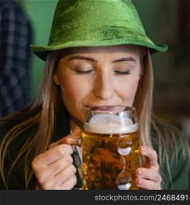front view woman with hat celebrating st patrick s day with drink