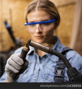 front view woman with welding device