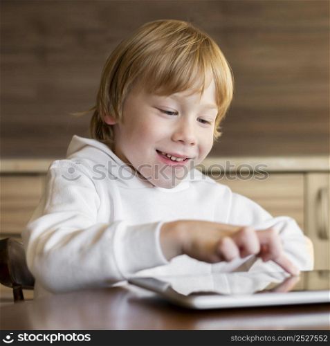 front view young boy using tablet