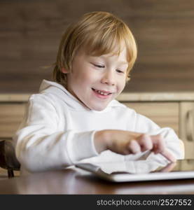 front view young boy using tablet