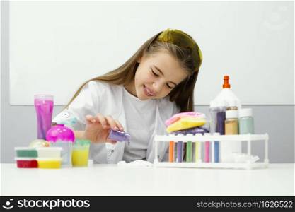 front view young girl scientist experimenting with slime colors