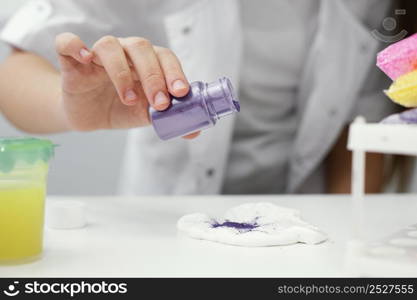 front view young girl scientist experimenting with slime pigments