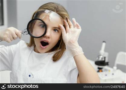 front view young girl scientist using magnifying glass