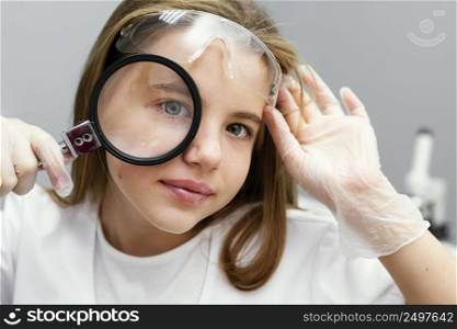front view young girl scientist with magnifying glass