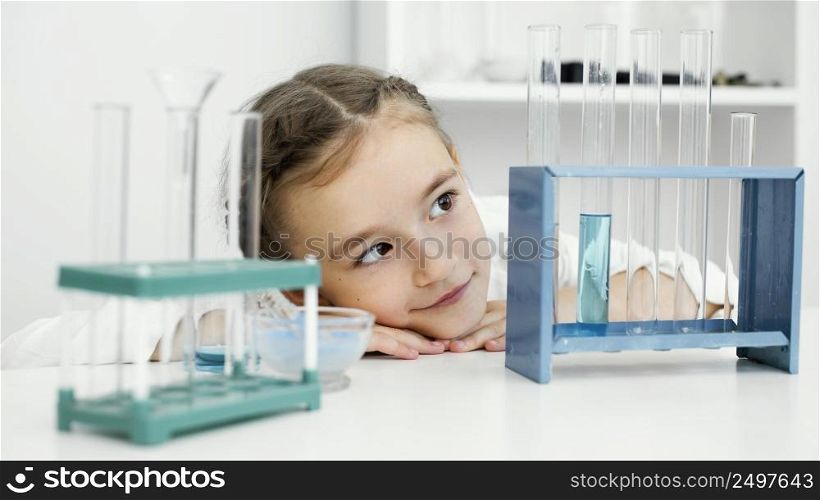 front view young girl scientist with test tubes lab