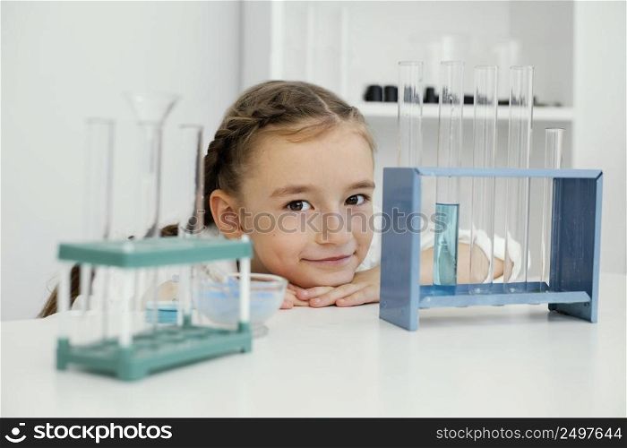 front view young girl scientist with test tubes laboratory