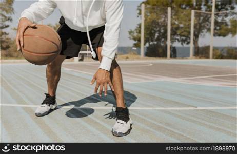 front view young man playing basketball outside 2. Resolution and high quality beautiful photo. front view young man playing basketball outside 2. High quality beautiful photo concept