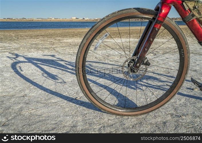 front wheel of lightweight`l or touring bike with a carbon frame on a lake shore - Boyd Lake State Park, Colorado