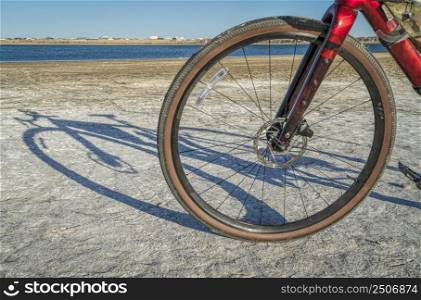 front wheel of lightweight`l or touring bike with a carbon frame on a lake shore - Boyd Lake State Park, Colorado