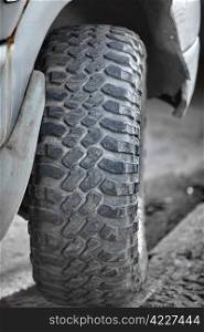 Front wheel off-road vehicle tread close up. Wheel an SUV