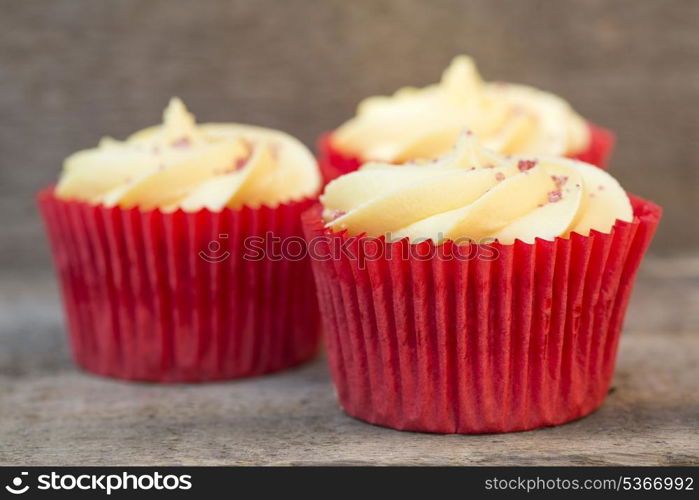 Frosted cupcakes on rustic background. Frosted cupcakes