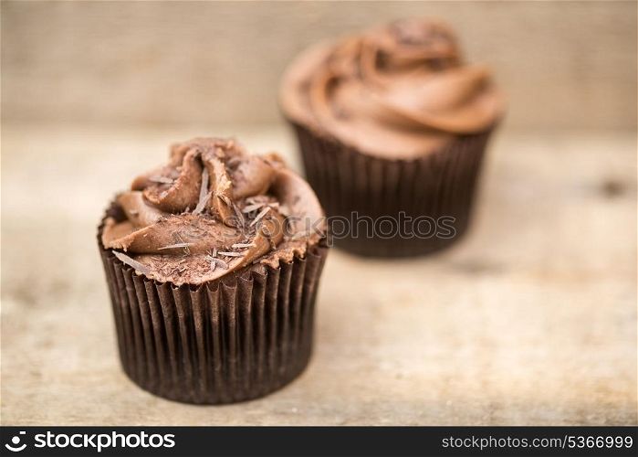 Frosted cupcakes on rustic background. Frosted cupcakes