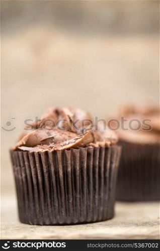 Frosted cupcakes on rustic background. Frosted cupcakes