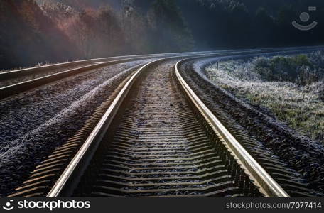 Frosty autumn morning on the railway. There ascends the sun.