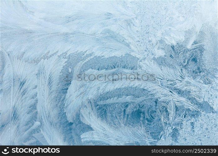 Frosty ice pattern on winter window glass