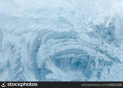 Frosty ice pattern on winter window glass