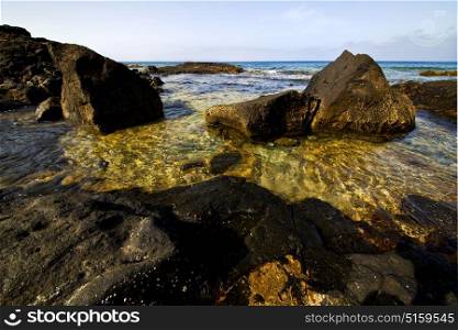 froth coastline in lanzarote spain pond rock stone sky cloud beach water musk and summer