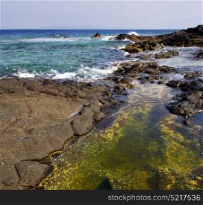 froth coastline in lanzarote spain pond rock stone sky cloud beach water musk and summer