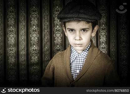 Frowning child in vintage clothes and hat. Close up shot