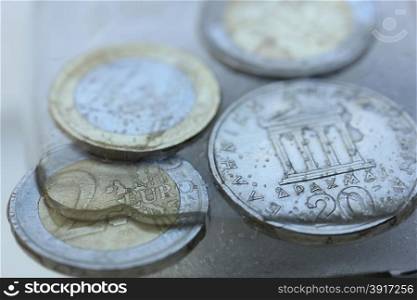 Frozen Assets: Greek euro and Drachme coins in ice