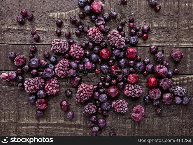 Frozen berries mix on wooden background. Still life photography