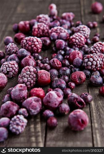 Frozen berries mix on wooden background. Still life photography