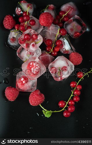 Frozen berries on wooden table. Fresh frozen berries raspberry and red currant