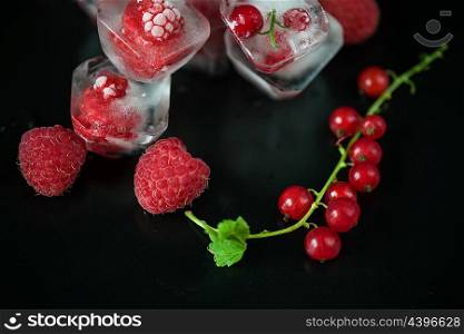 Frozen berries on wooden table. Fresh frozen berries raspberry and red currant